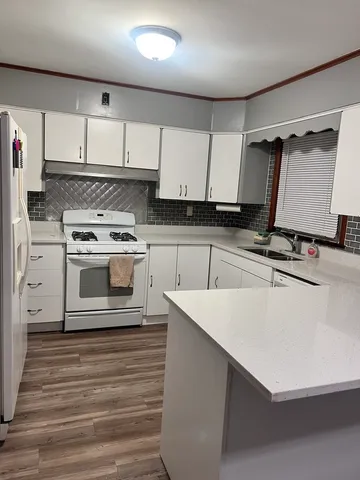 a kitchen with cabinets appliances and a counter space
