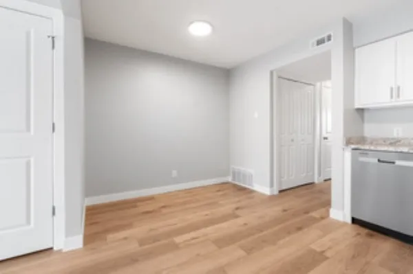 a view of empty room with wooden floor