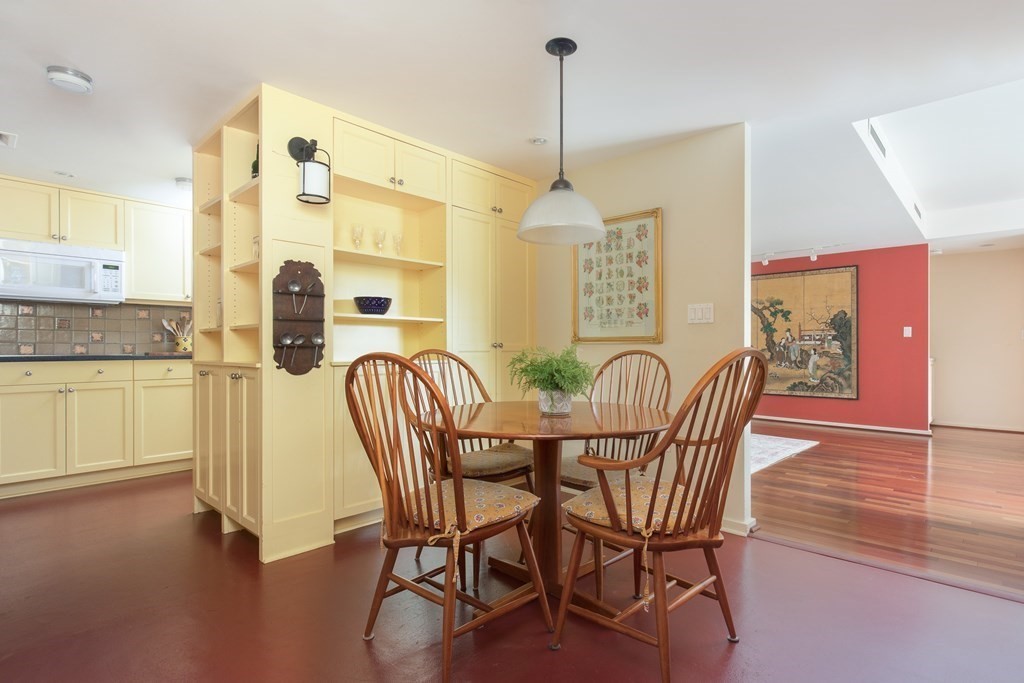 130 Mt Auburn Street, Unit 310 Cambridge, MA 02138 - Photo 16 of 21 a view of a dining room with furniture and wooden floor