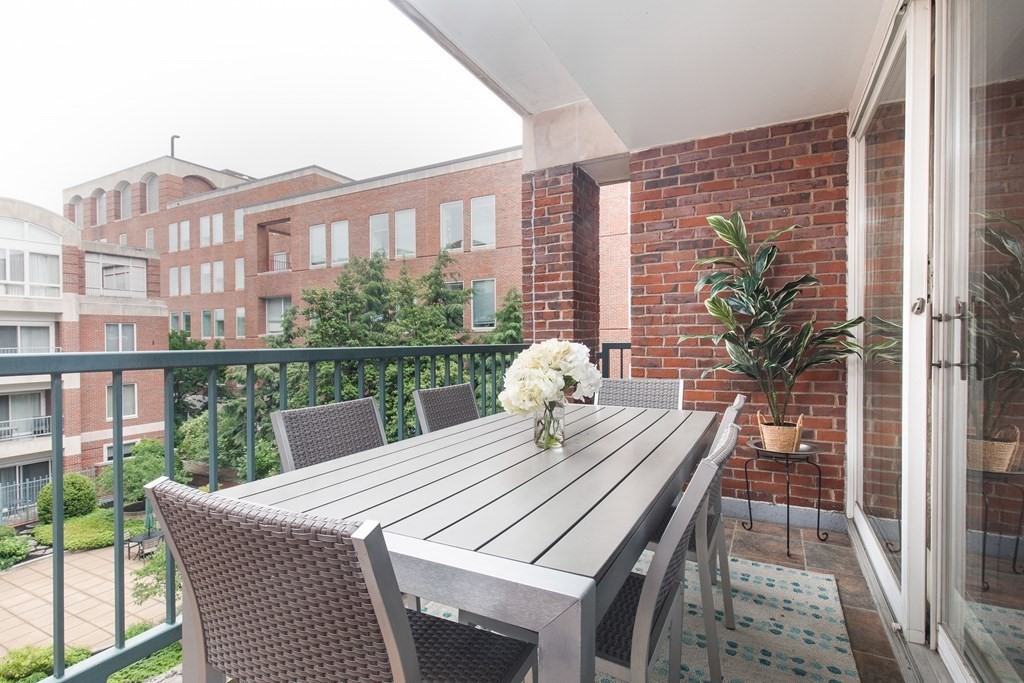130 Mt Auburn Street, Unit 310 Cambridge, MA 02138 - Photo 19 of 21 a view of a city from a balcony with furniture