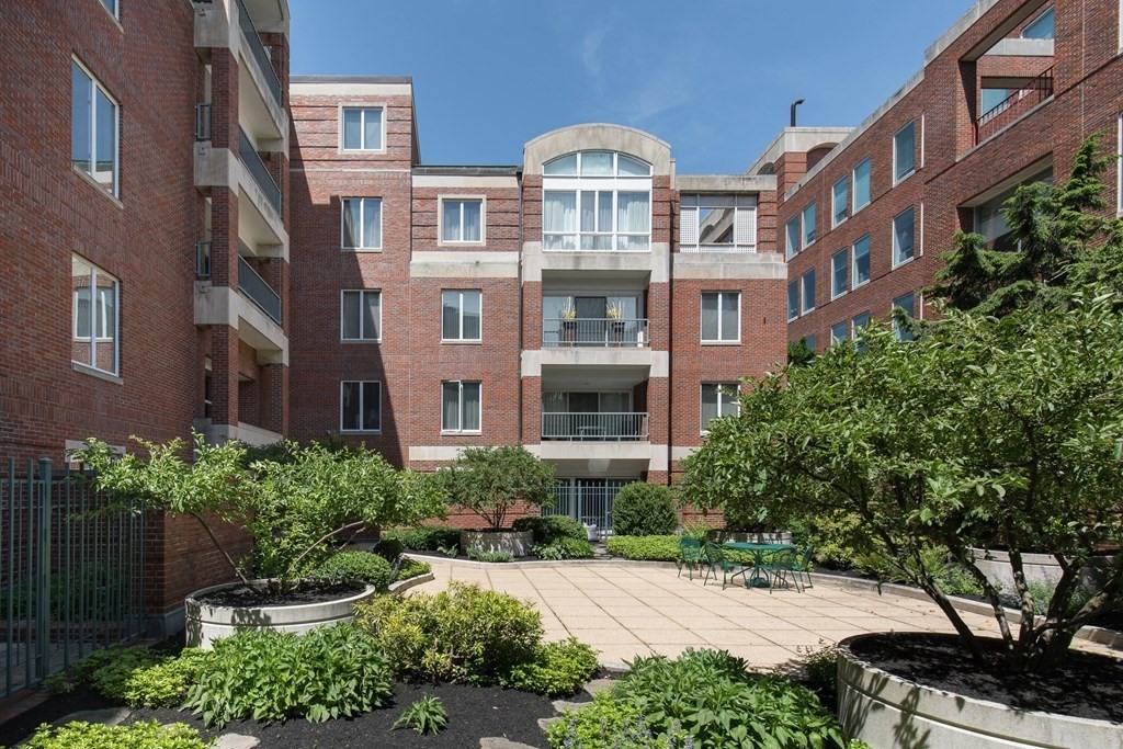 130 Mt Auburn Street, Unit 310 Cambridge, MA 02138 - Photo 2 of 21 a front view of a multi story residential apartment building with a yard