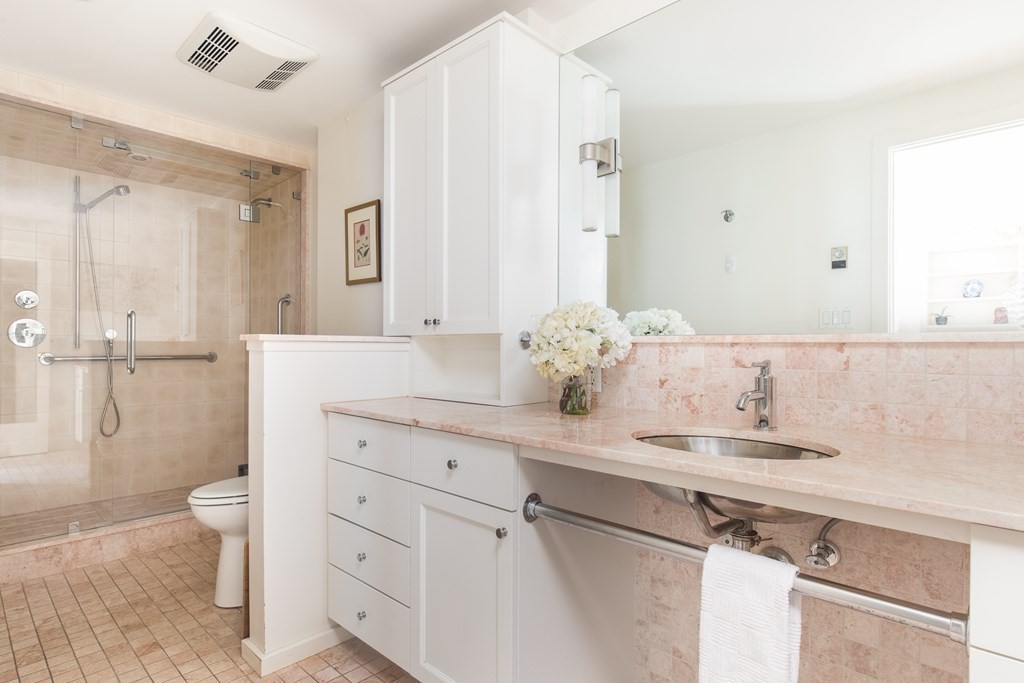 130 Mt Auburn Street, Unit 310 Cambridge, MA 02138 - Photo 10 of 21 a bathroom with a granite countertop sink and a mirror