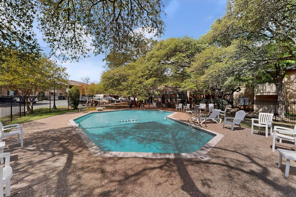 8210 Bent Tree Road, Unit 116 Austin, TX 78759 - Photo 18 of 21 Mature trees shade the inviting community swimming pool surrounded by a spacious concrete deck.