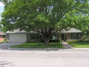 6207 Calumet Road Amarillo, TX 79106 - Photo 1 of 1 a front view of a house with a yard and a garage