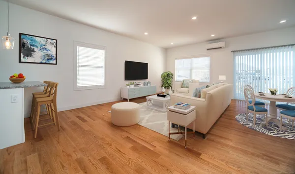a living room with furniture a flat screen tv and a large window