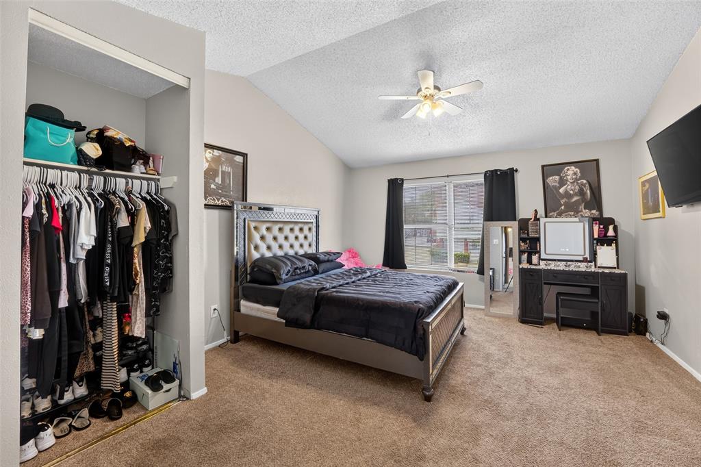 10500 Lake June Road, Unit L07 Dallas, TX 75217 - Photo 13 of 14 Vaulted ceiling, ceiling fan with integrated lighting, carpeted flooring, window with blinds, and an open closet