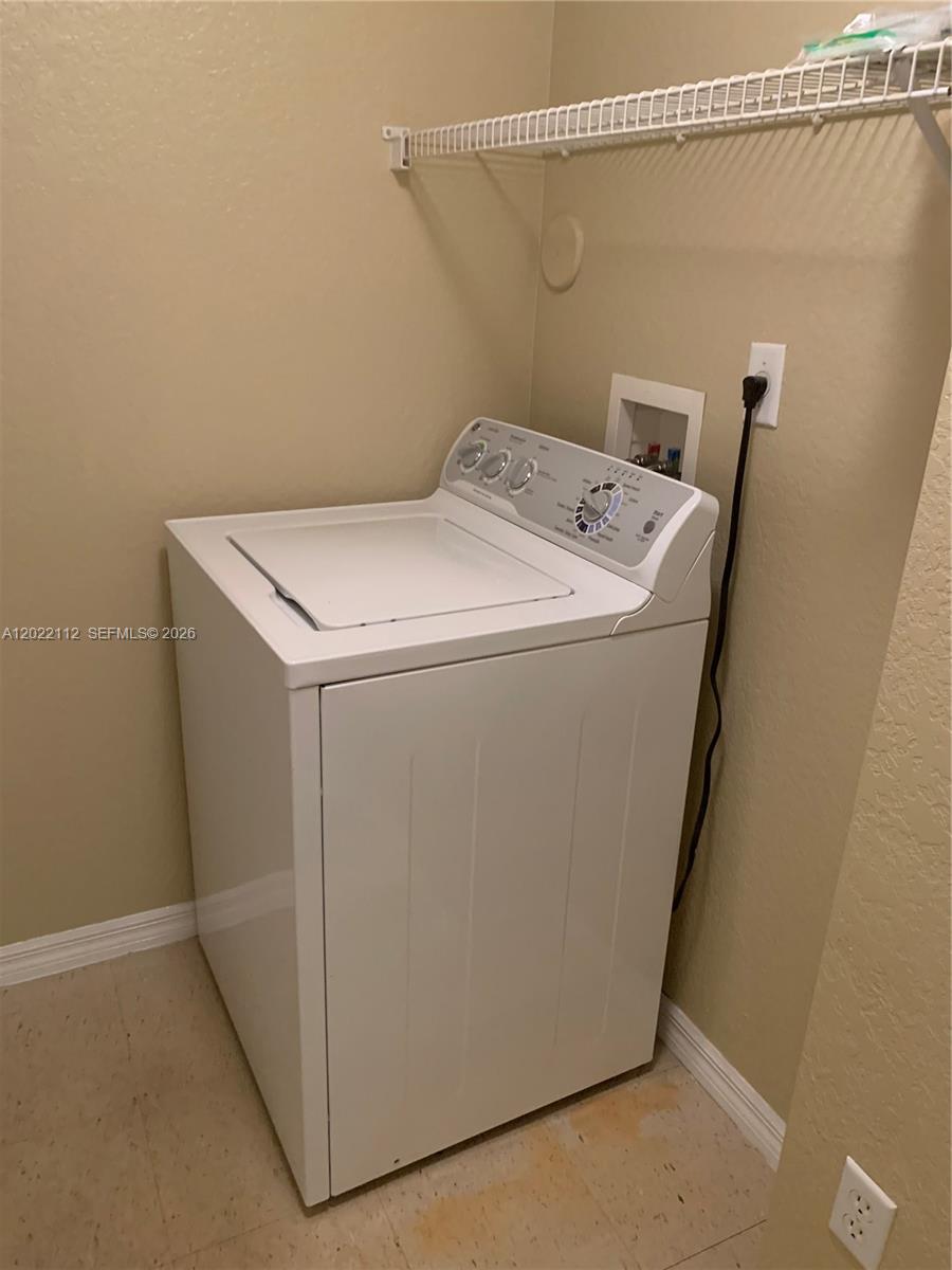 6572 West Sample Road, Unit 6572 Coral Springs, FL 33067 - Photo 7 of 17 a utility room with dryer and washer
