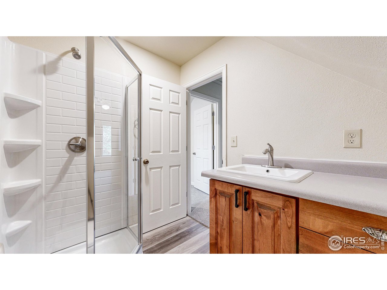 80 Hot Spur Lane Drake, CO 80515 - Photo 27 of 40 a bathroom with a sink a mirror and shower