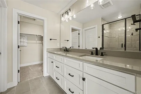 a bathroom with a granite countertop sink mirror and double