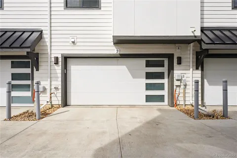 a view of a house with a door and a car parked side of road