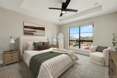 a bedroom with a bed a couch and a window