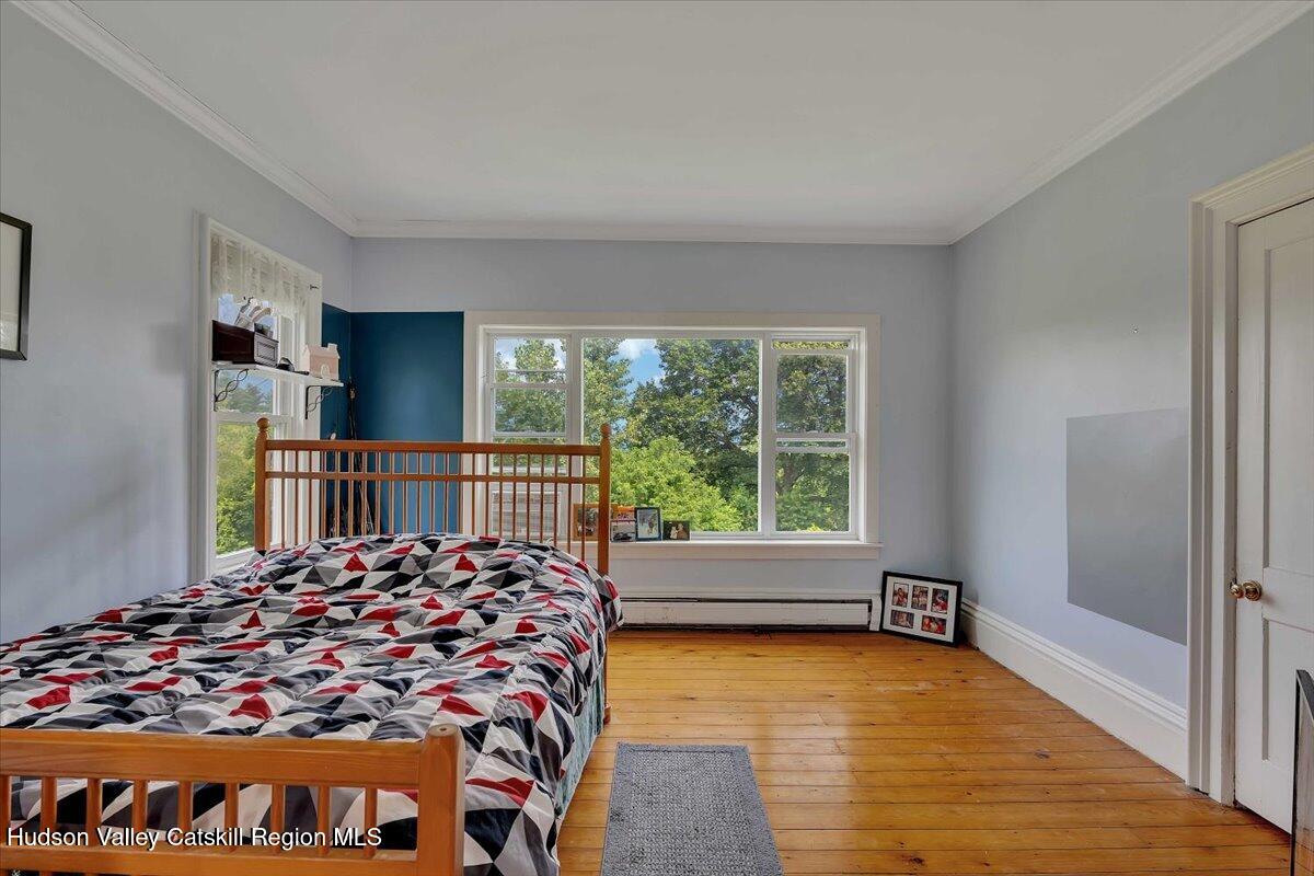 1670 County Rte 30 Salem, NY 12865 - Photo 42 of 59 a large bed sitting in a bedroom next to a window