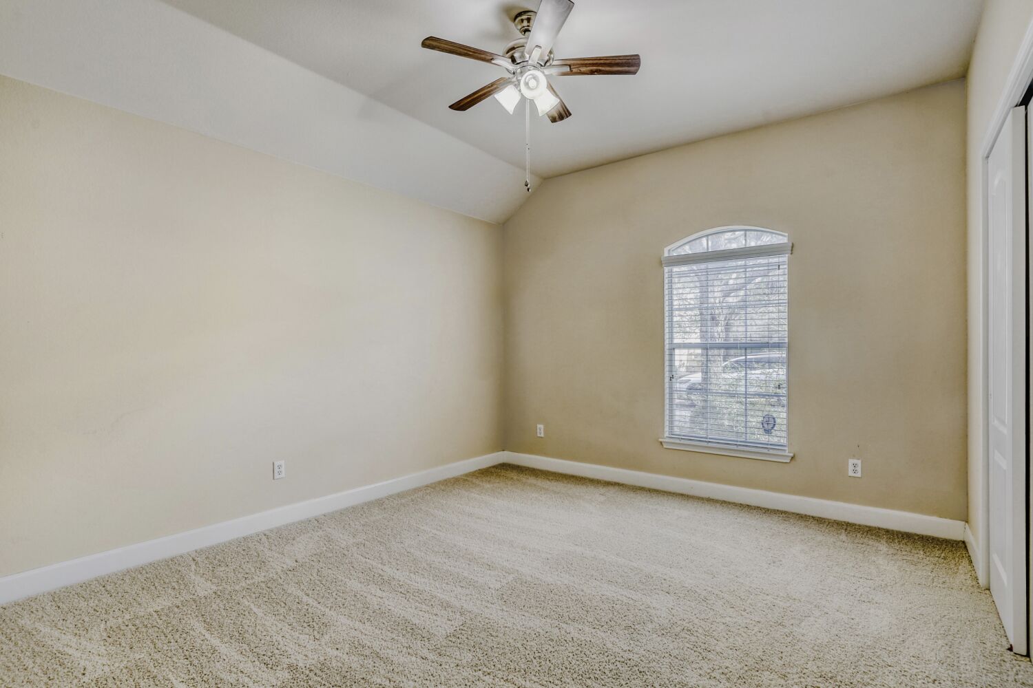 24 Stone Terrace Drive Austin, TX 78734 - Photo 17 of 31 Unfurnished room featuring light carpet, ceiling fan, and vaulted ceiling