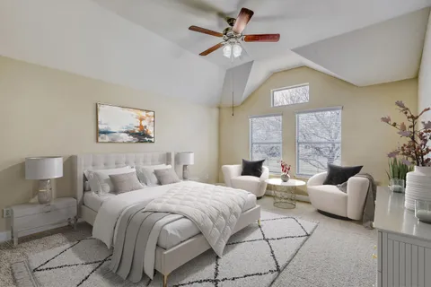 a living room with furniture a fireplace and a floor to ceiling window