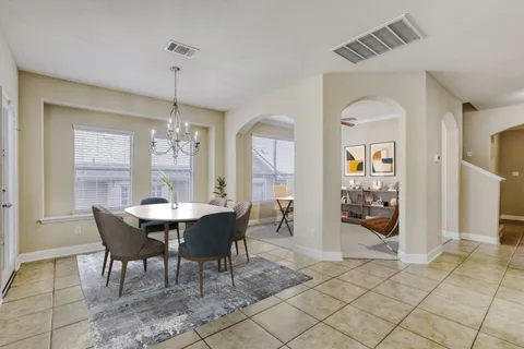 a living room with furniture a fireplace and a floor to ceiling window
