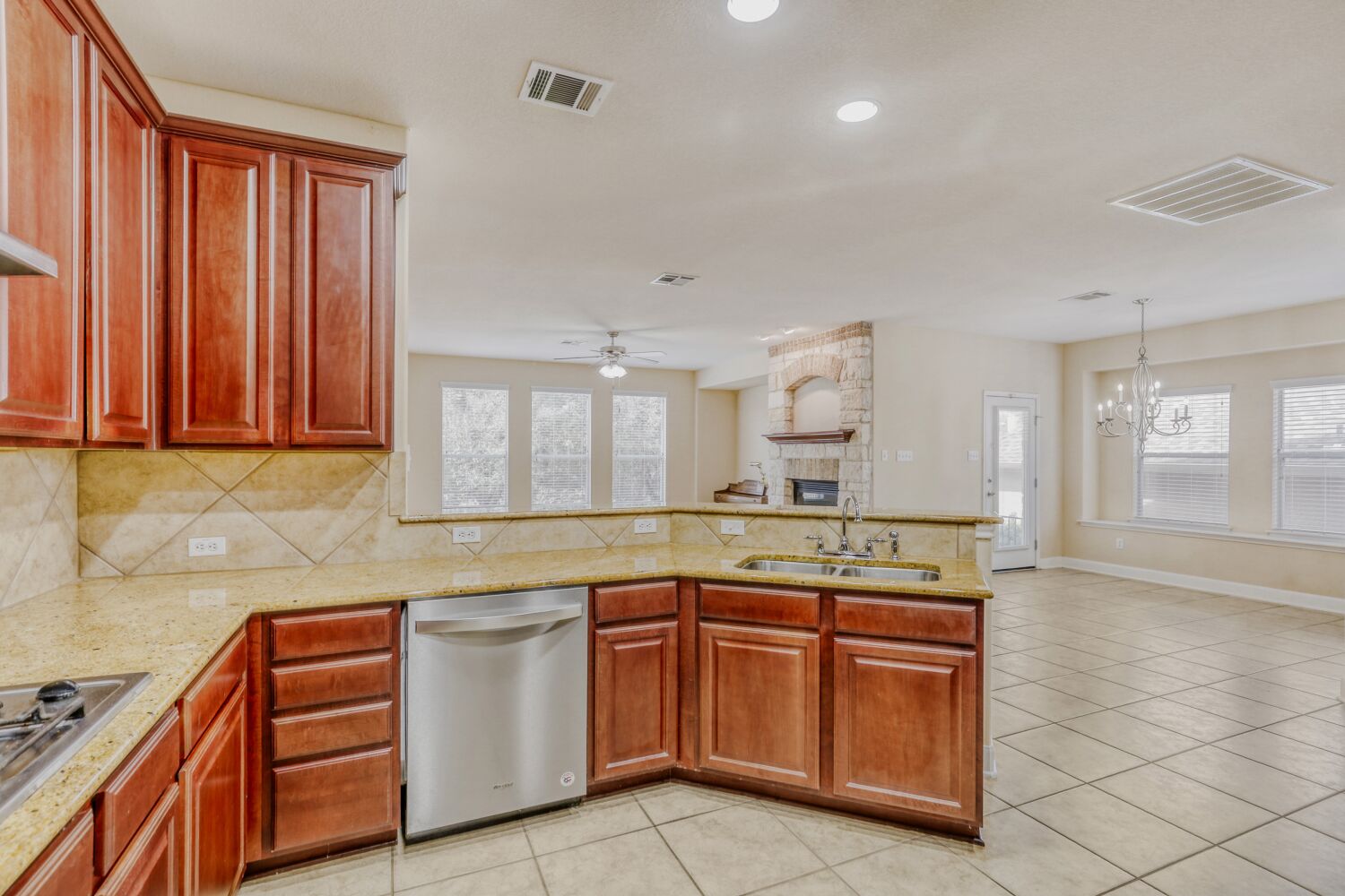 24 Stone Terrace Drive Austin, TX 78734 - Photo 30 of 31 Kitchen featuring a bar, light stone countertops, stainless steel appliances, and open floor plan