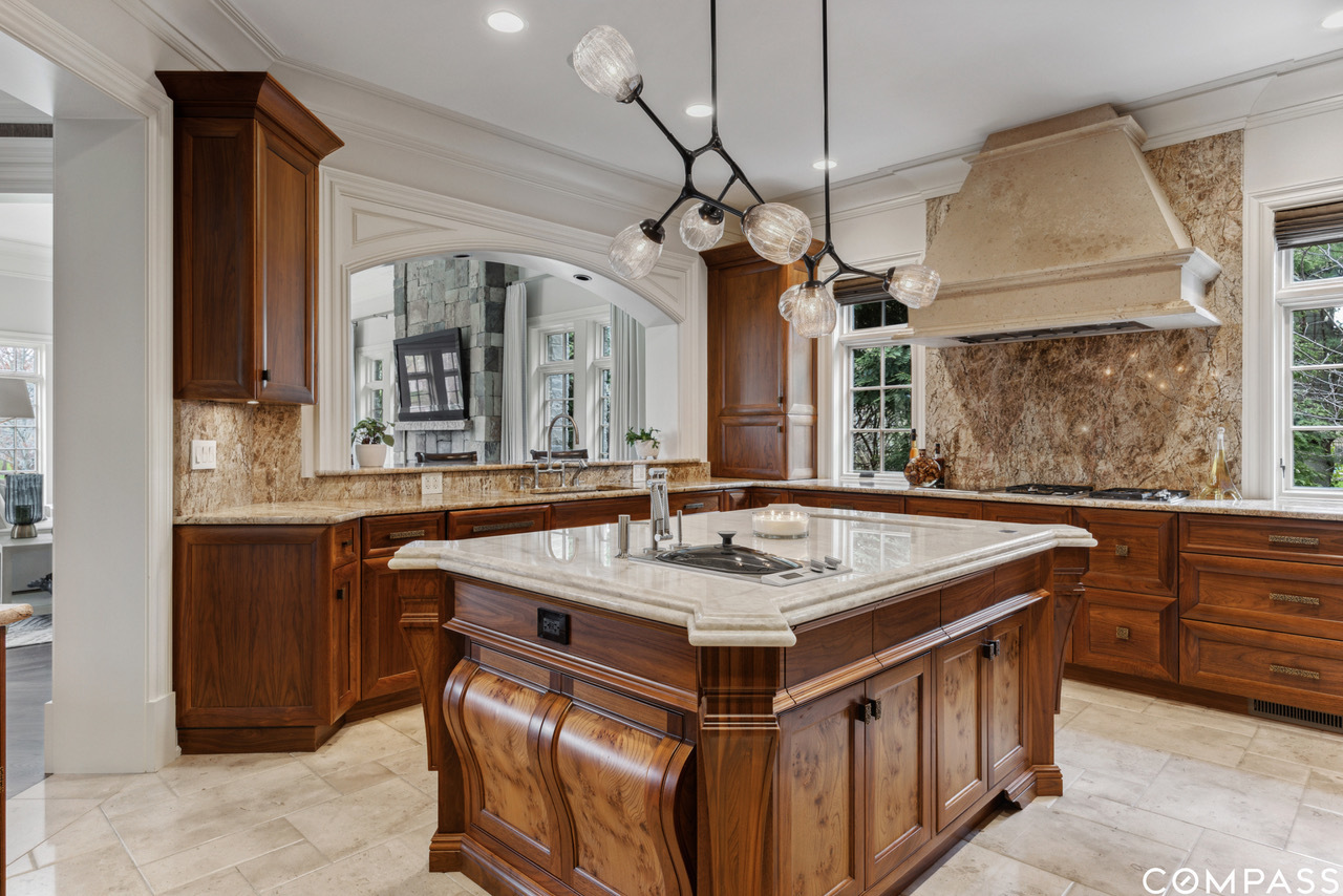 106 Longmeadow Road Winnetka, IL 60093 - Photo 14 of 66 a kitchen that has a sink a stove and a table in it