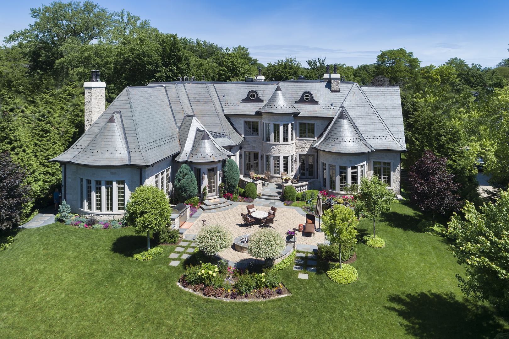 106 Longmeadow Road Winnetka, IL 60093 - Photo 10 of 66 a aerial view of a house with table and chairs under an umbrella