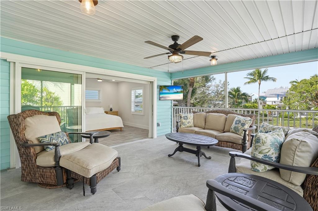 270 Dundee Road Fort Myers Beach, FL 33931 - Photo 34 of 48 Sunroom / solarium with an outdoor living space and a ceiling fan - Virtually Edited Image