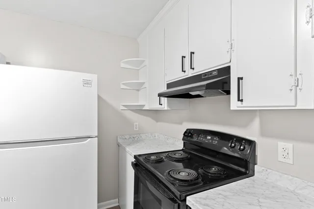a kitchen with cabinets and appliances