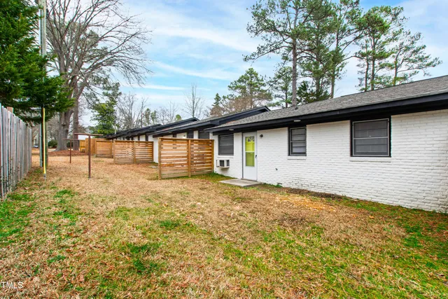 a view of an empty room with a window and back yard