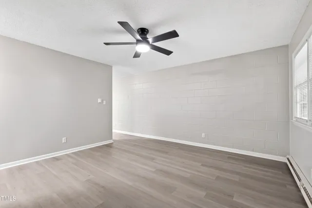 wooden floor in an empty room with a window
