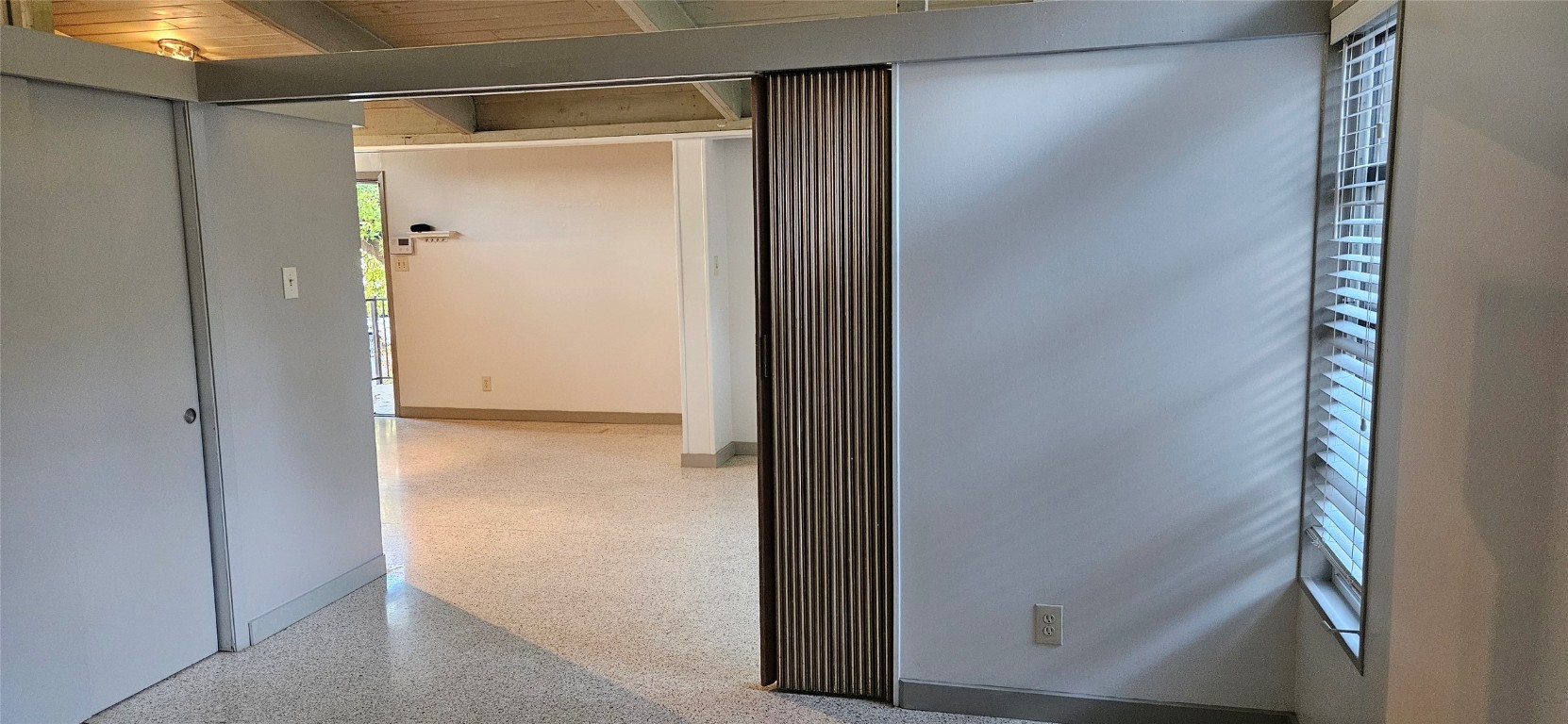 506 West 7th Street, Unit B Austin, TX 78701 - Photo 14 of 14 Hall featuring speckled floor and beamed ceiling