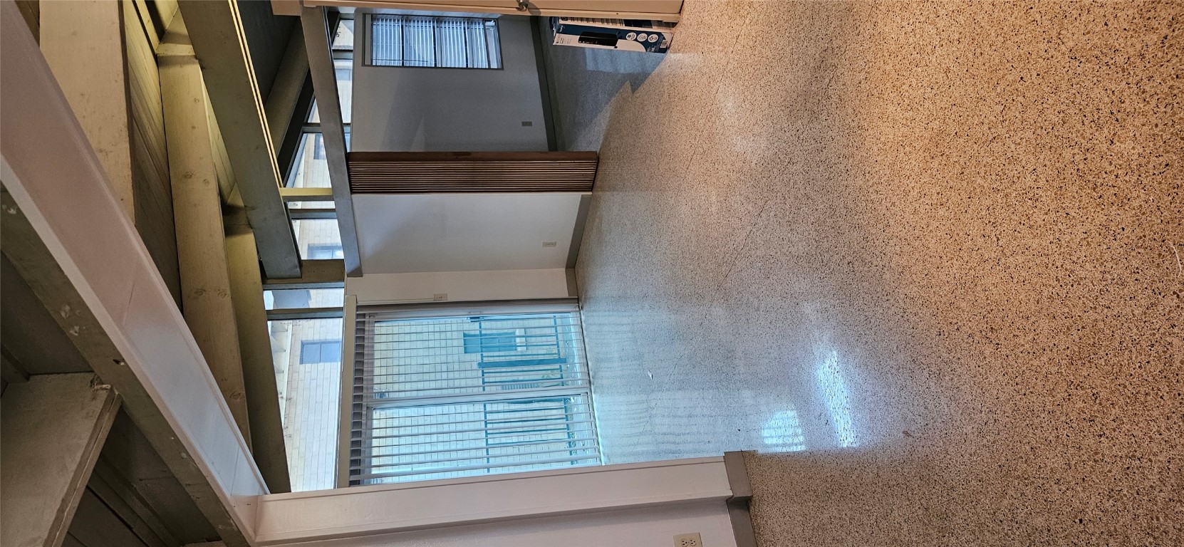 506 West 7th Street, Unit B Austin, TX 78701 - Photo 6 of 14 Spare room featuring beamed ceiling and dark speckled floor