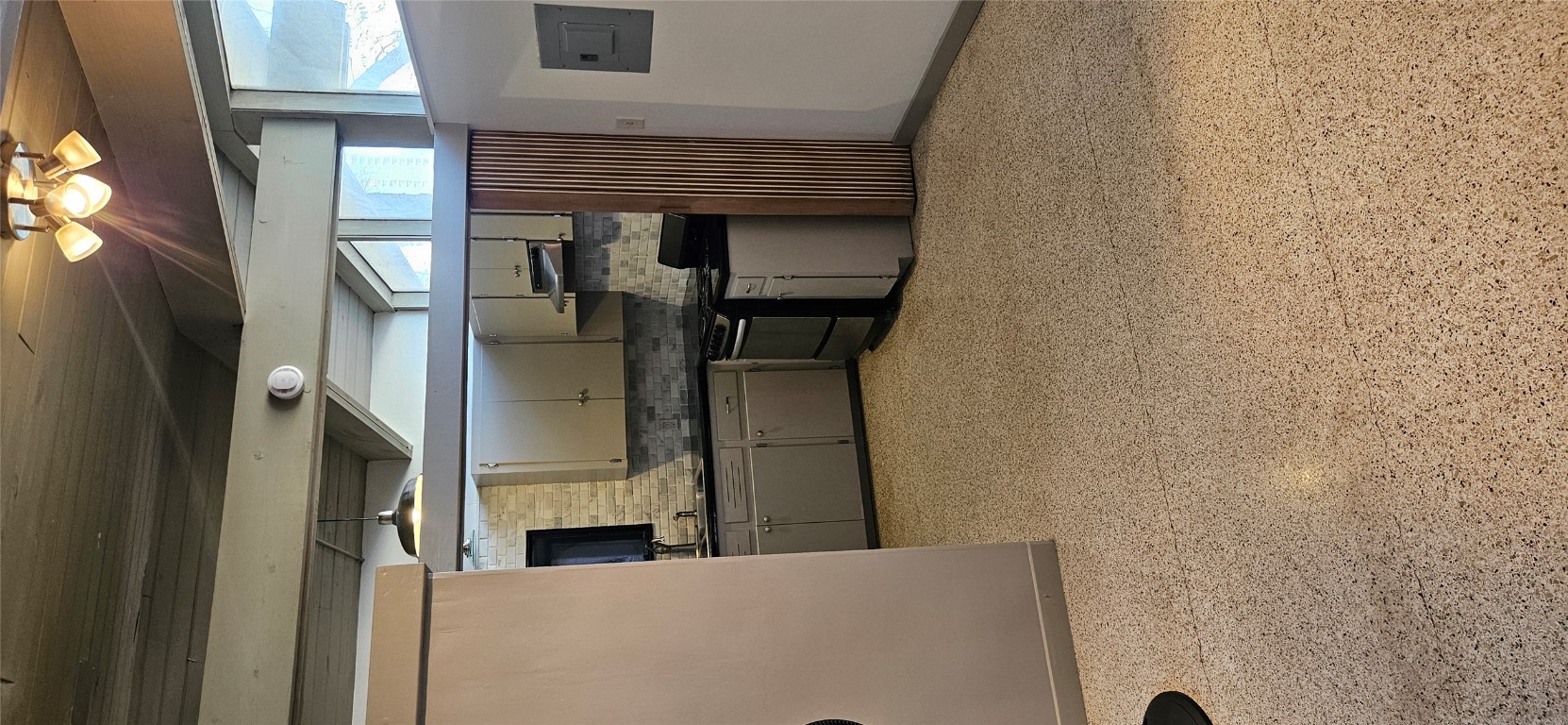 506 West 7th Street, Unit B Austin, TX 78701 - Photo 7 of 14 Kitchen with dark countertops, stainless steel range oven, a wood ceiling with exposed beams, tasteful backsplash, and electric panel