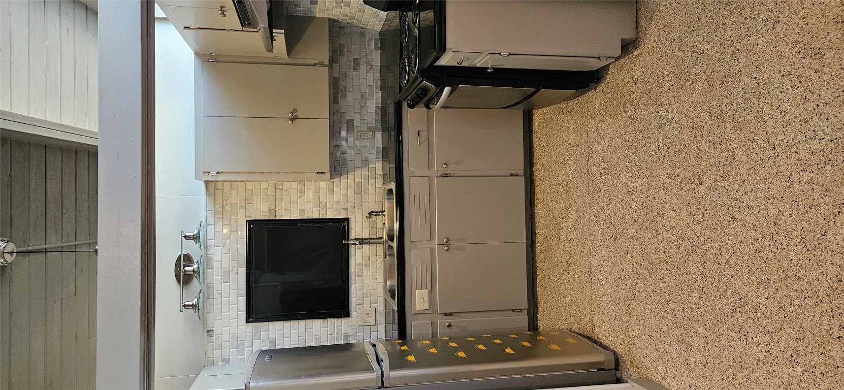 506 West 7th Street, Unit B Austin, TX 78701 - Photo 9 of 14 Kitchen with dark countertops, gas range, freestanding refrigerator, wooden ceiling, and under cabinet range hood