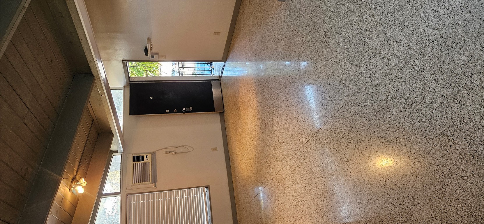 506 West 7th Street, Unit B Austin, TX 78701 - Photo 10 of 14 Empty room with a wood ceiling with exposed beams and dark speckled floor