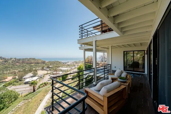 a view of a balcony with furniture