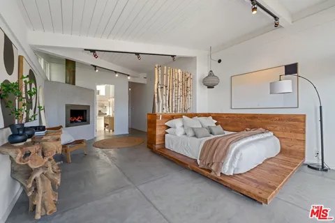 a bedroom with bed and a fireplace