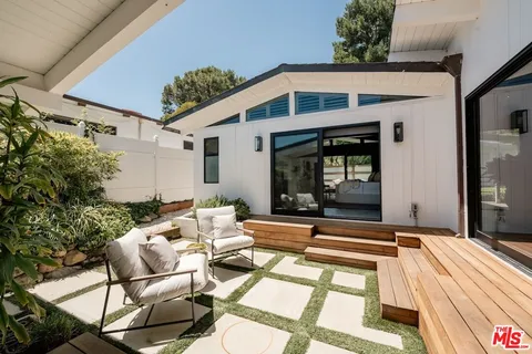 a view of house with swimming pool outdoor seating