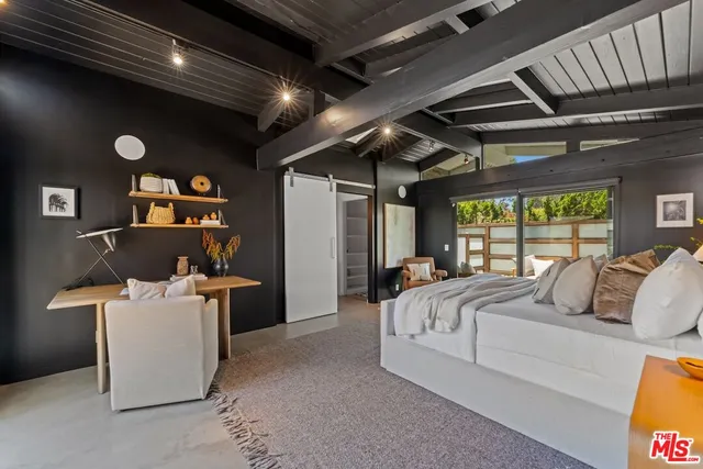 a bed room with a bed and a large window