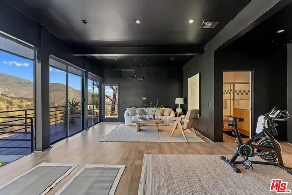 a living room with furniture a wooden floor and next to a window