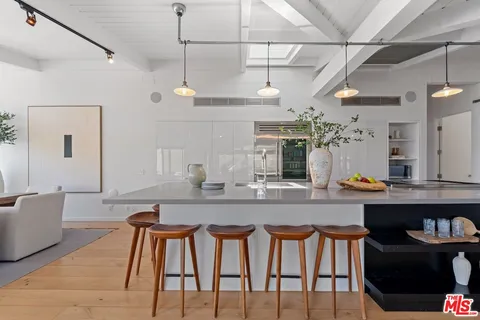 a dining table with chairs and cabinets