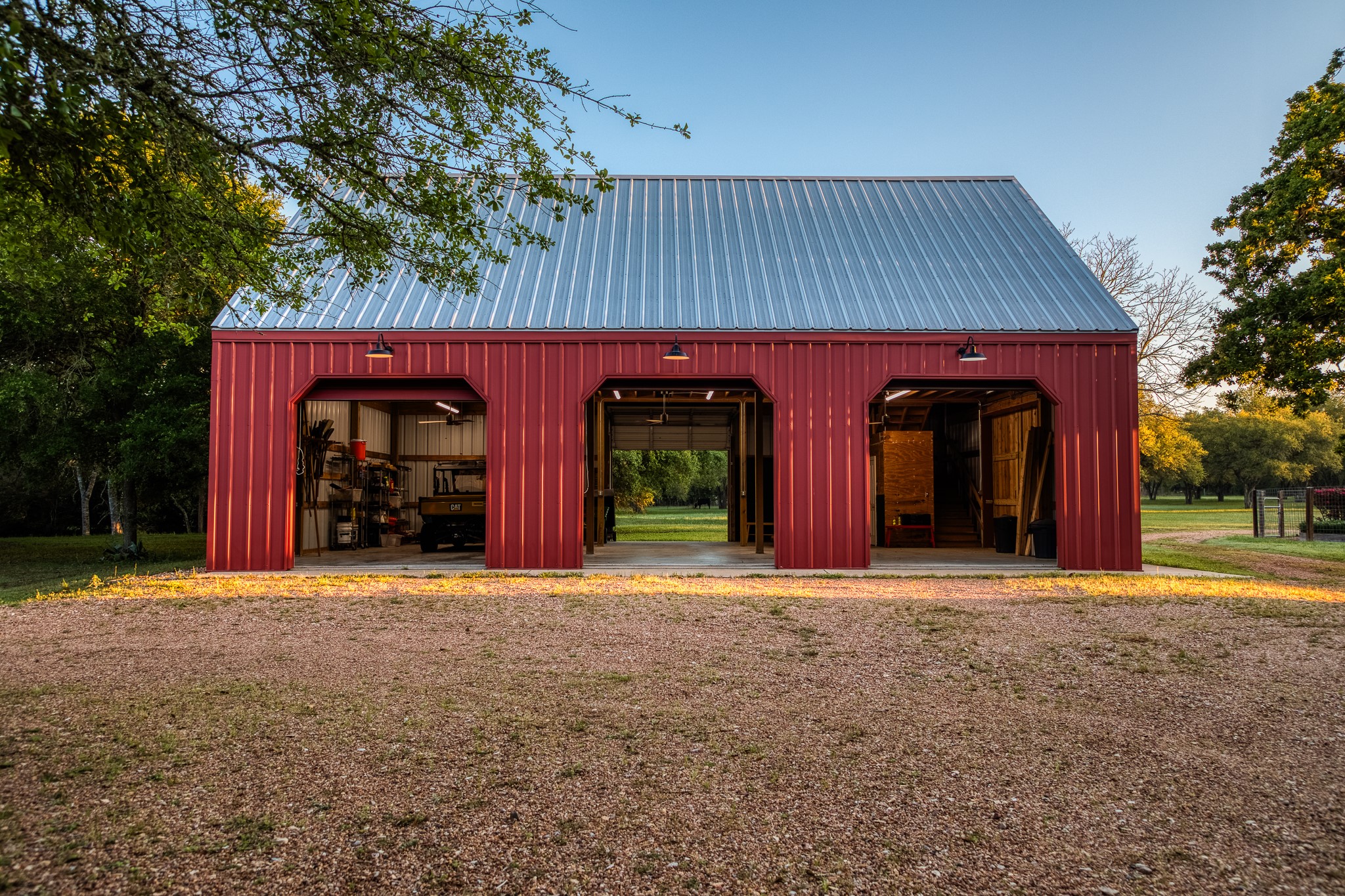 1585 Round Top Road Round Top, TX 78954 - Photo 21 of 26 a front view of a house with large trees and plants