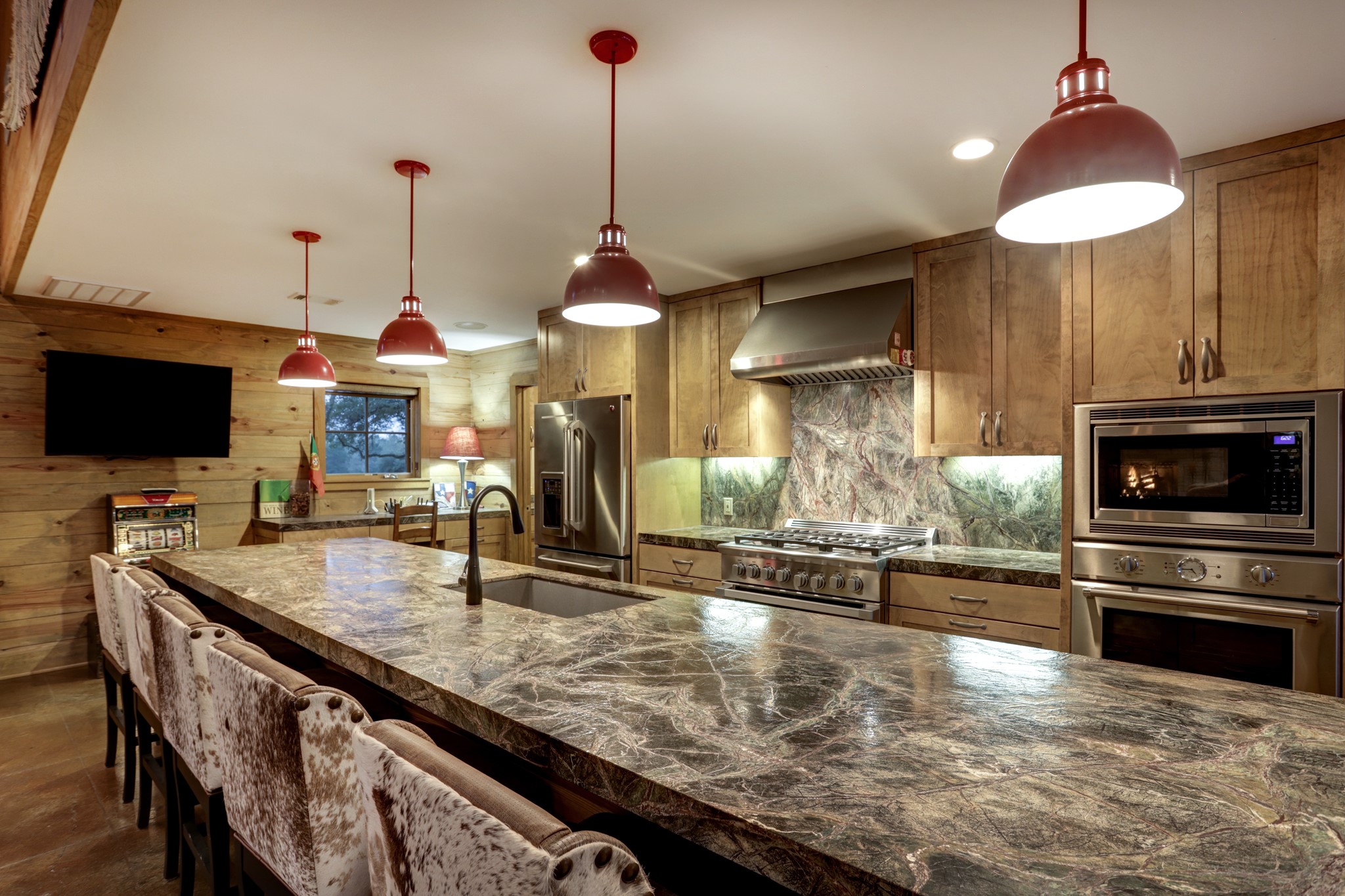 1585 Round Top Road Round Top, TX 78954 - Photo 5 of 26 a kitchen with stainless steel appliances granite countertop a sink a stove and a wooden floor