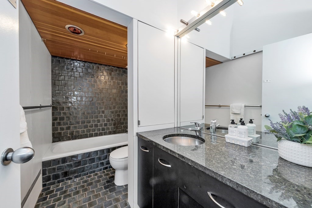 2 Field Road Lexington, MA 02421 - Photo 12 of 32 a bathroom with a granite countertop sink a toilet and shower