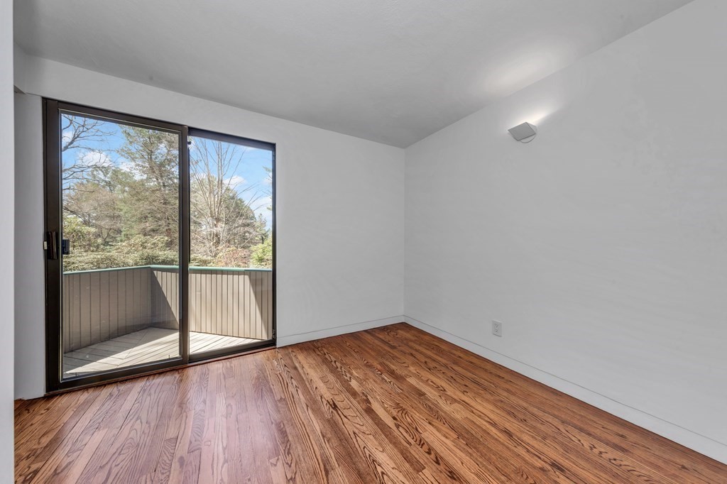 2 Field Road Lexington, MA 02421 - Photo 28 of 32 a view of empty room with wooden floor and fan