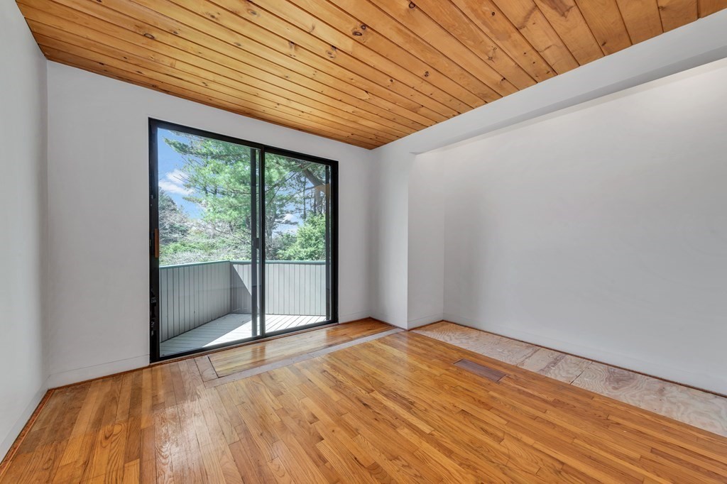 2 Field Road Lexington, MA 02421 - Photo 29 of 32 a view of an empty room with wooden floor and a window