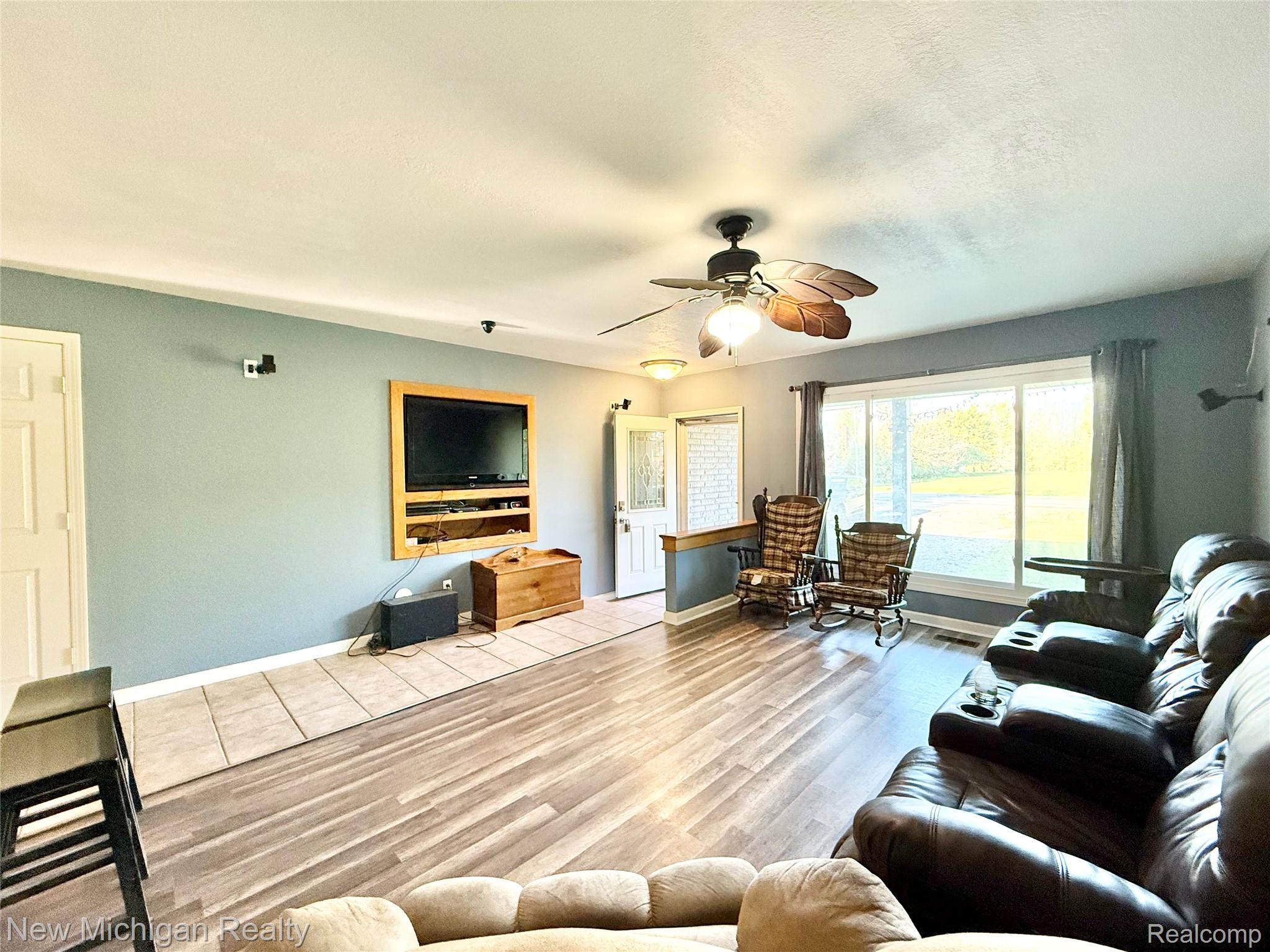 5288 Torrey Road Flint, MI 48507 - Photo 4 of 41 Living area with wood finished floors and ceiling fan