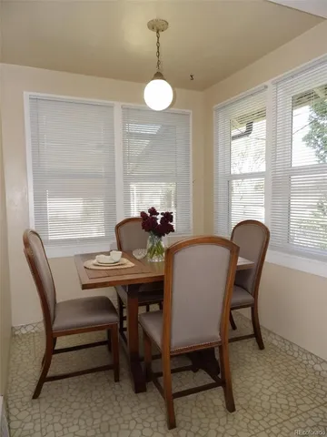 a dining room with furniture and window