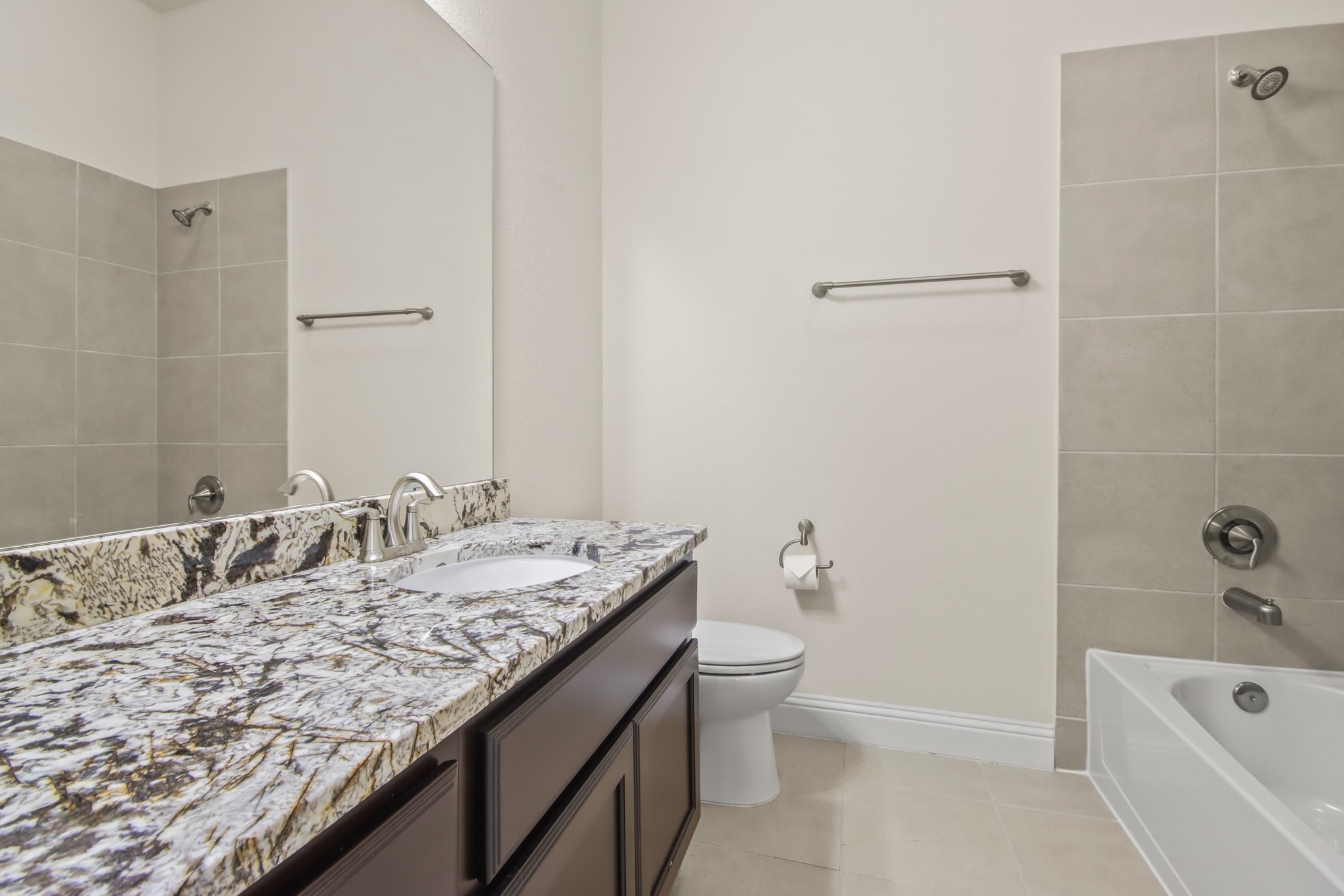 8931 Leaning Hollow Lane Spring, TX 77379 - Photo 24 of 38 The attached Bathroom for the secondary bedroom. Well designed with gorgeous granite, bright lighting and beautiful tile floors.