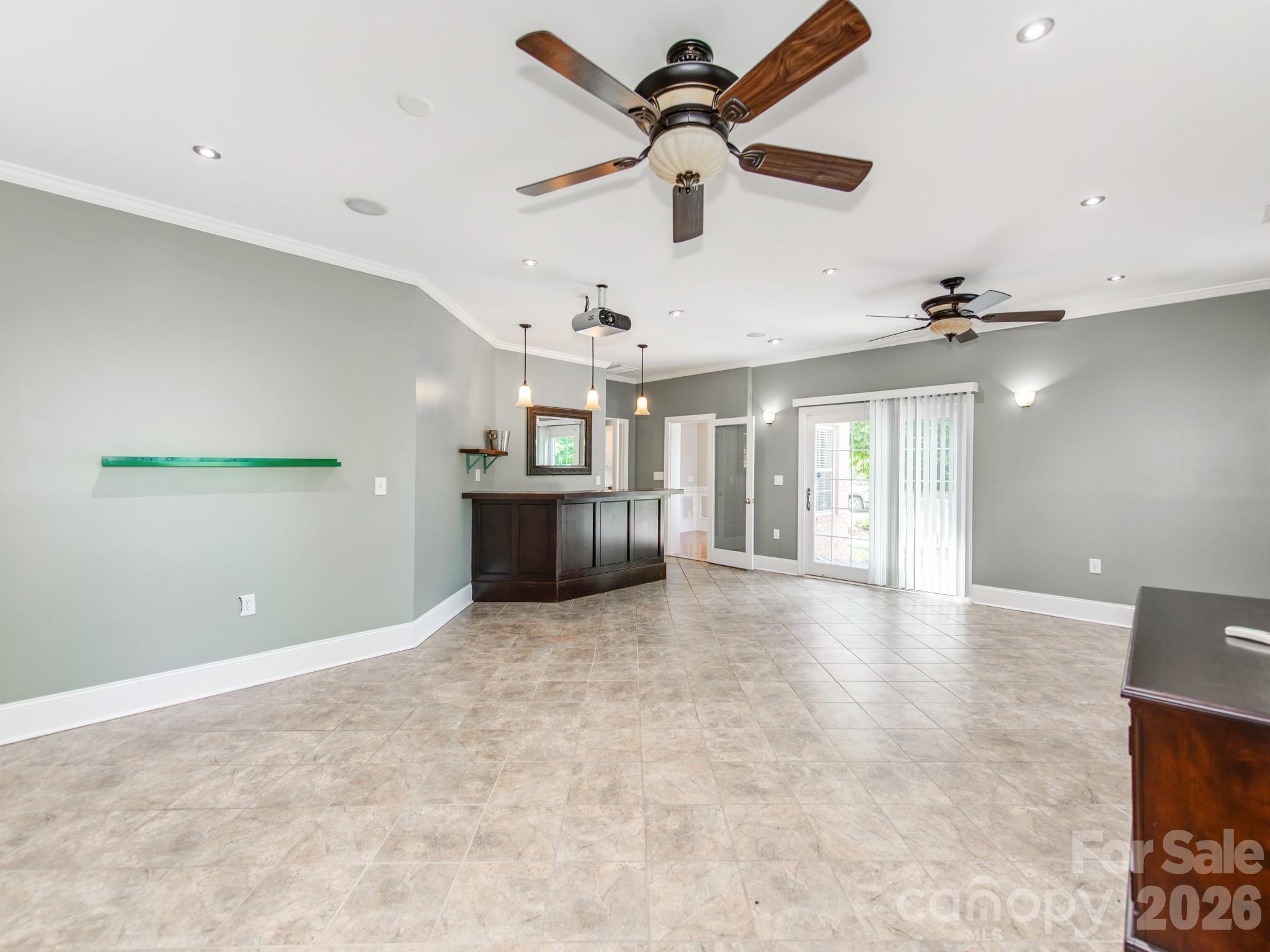 783 Sloan Street Denver, NC 28037 - Photo 14 of 44 an empty room with ceiling fan and windows