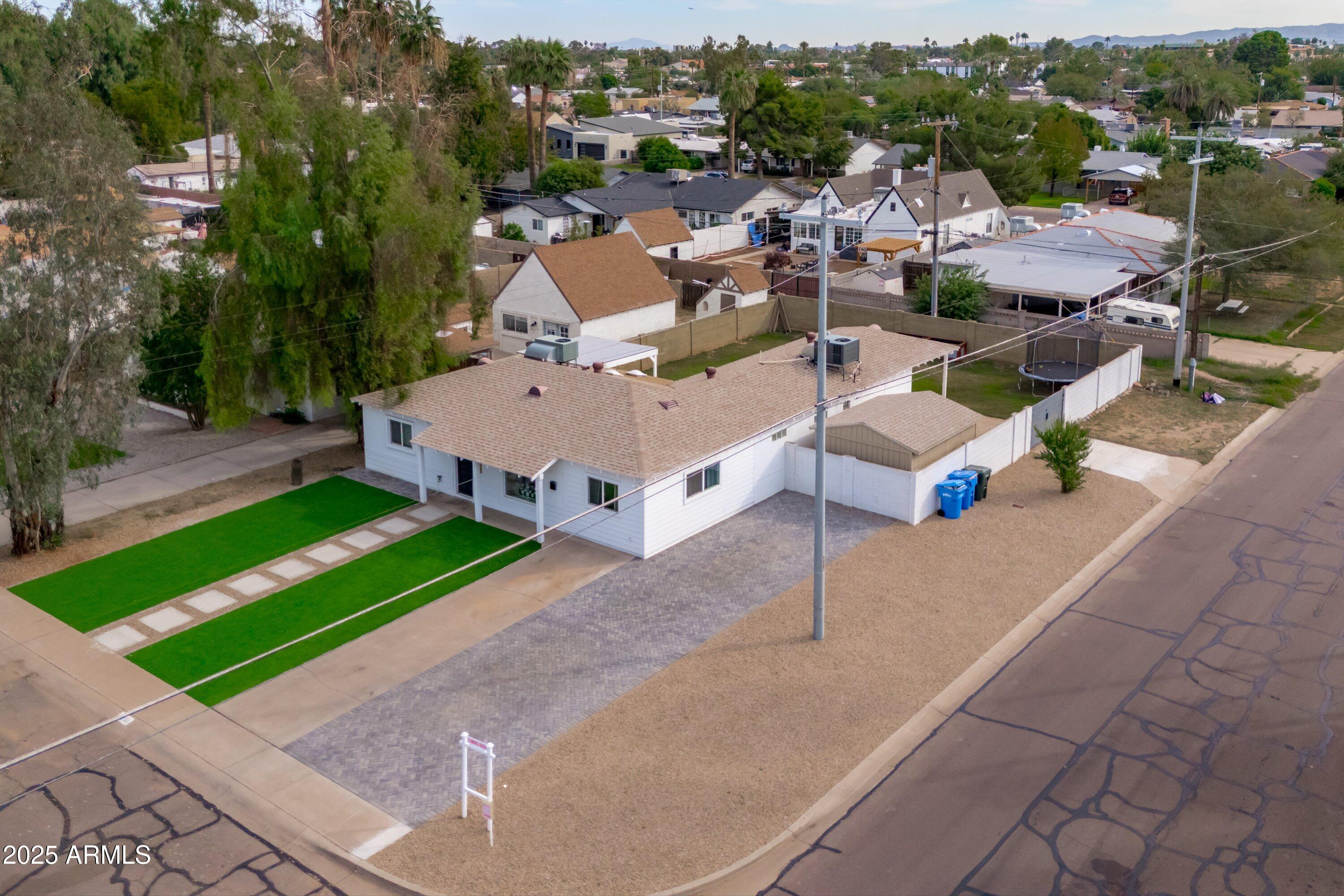 an aerial view of a house with a yard and lake view