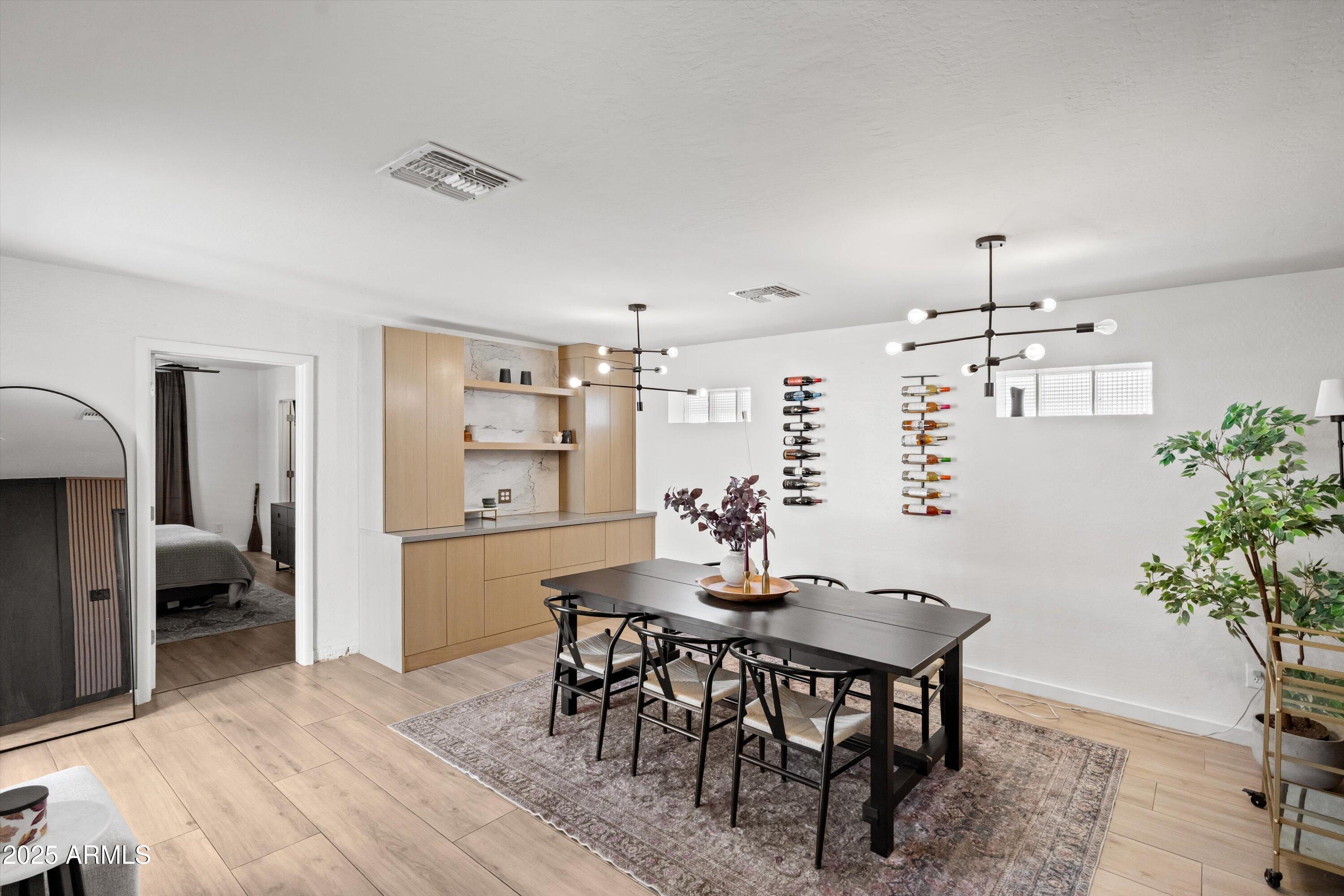 2201 East Weldon Avenue Phoenix, AZ 85016 - Photo 14 of 41 a view of a dining room with furniture and wooden floor