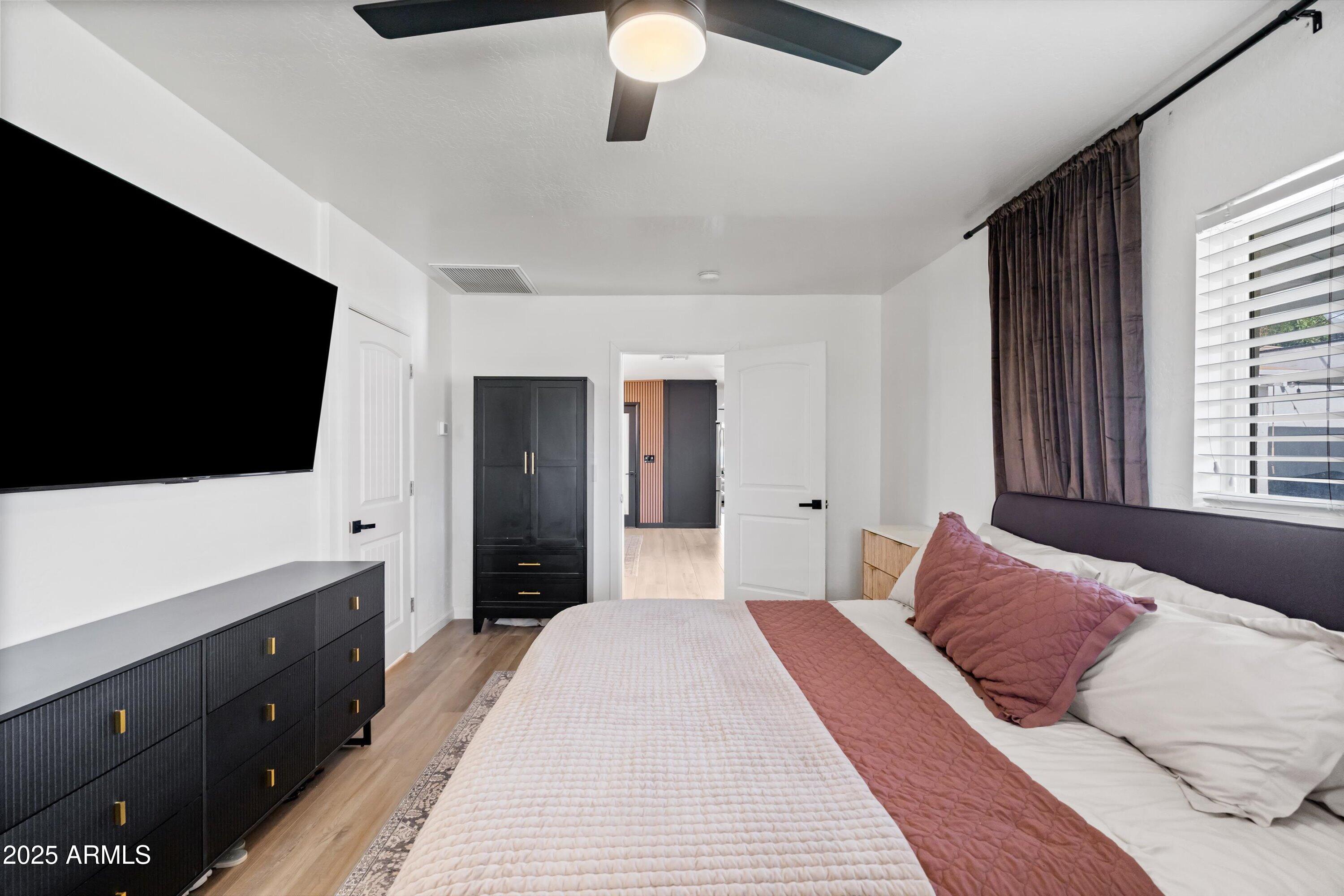 2201 East Weldon Avenue Phoenix, AZ 85016 - Photo 21 of 41 a bedroom with a bed and a flat tv screen on dresser