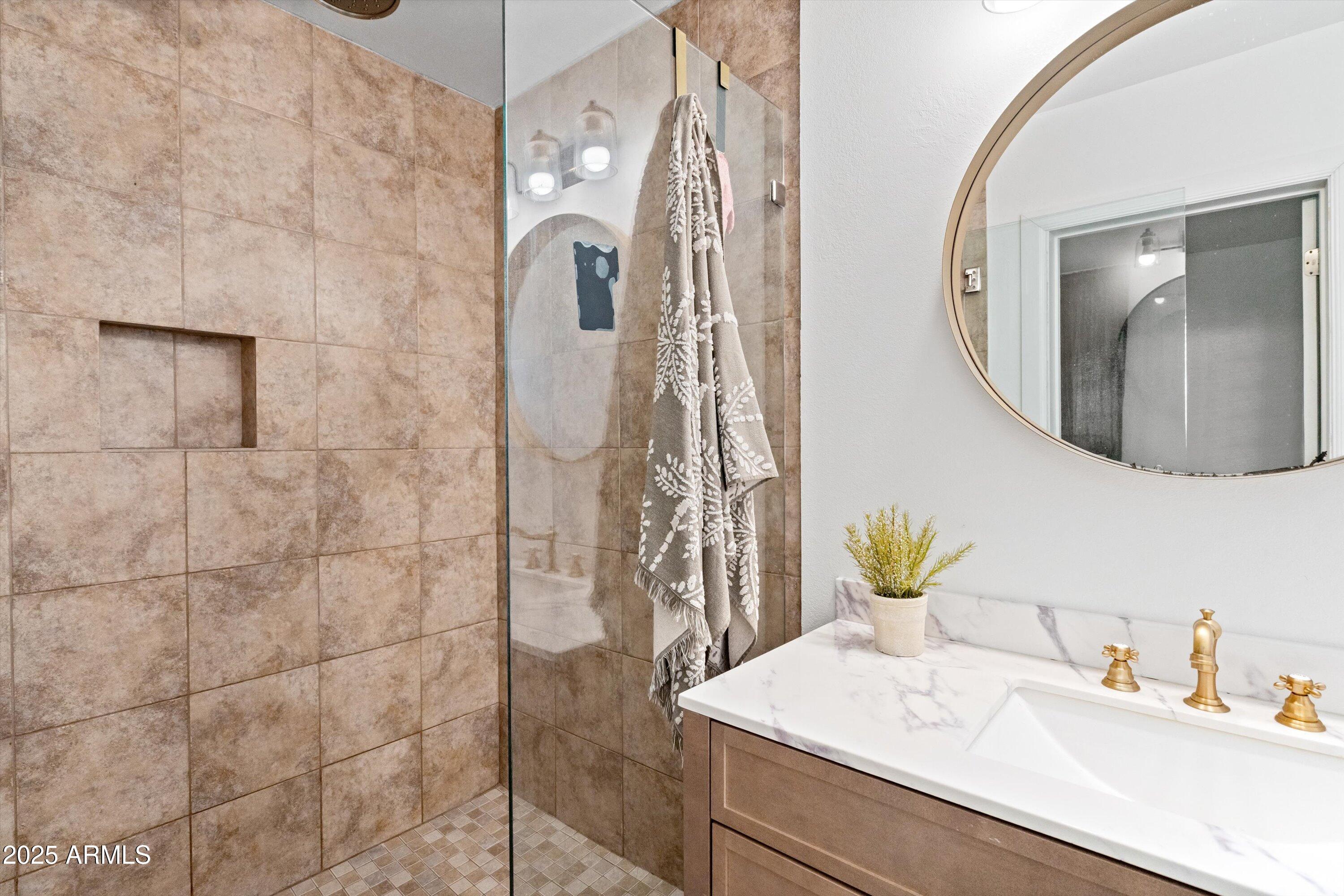 2201 East Weldon Avenue Phoenix, AZ 85016 - Photo 25 of 41 a bathroom with a granite countertop sink a mirror and shower